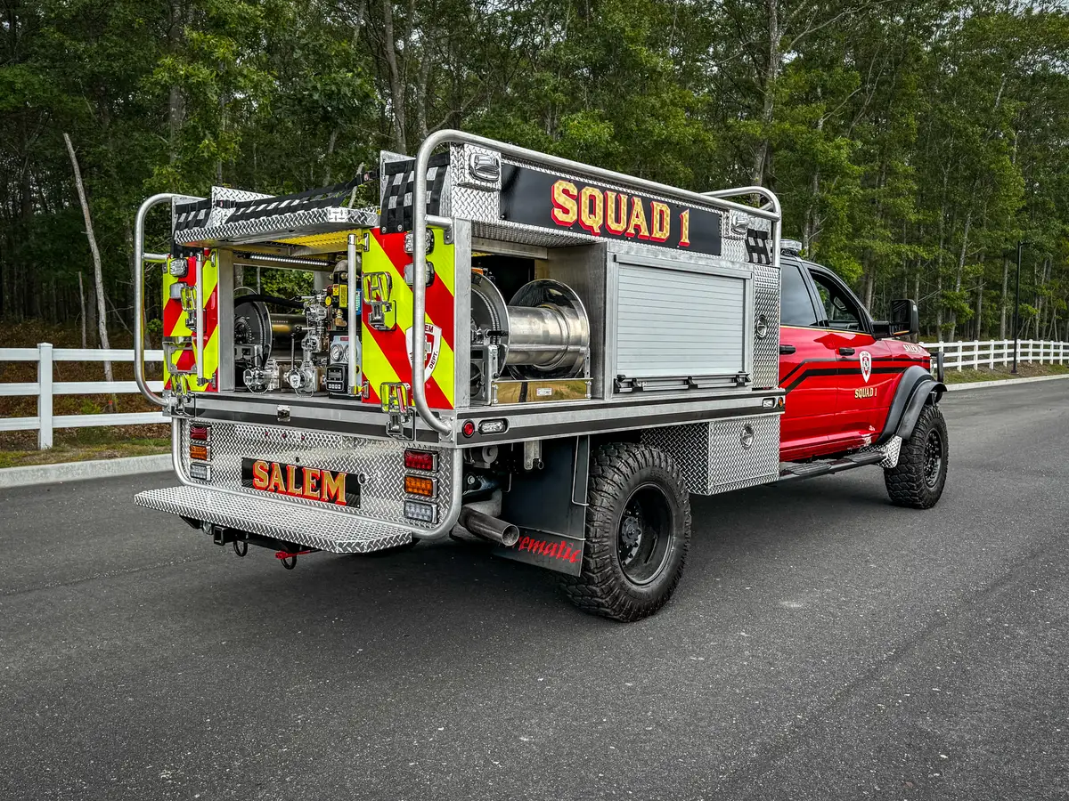 Rear-right three-quarter exterior view with open rear bay and side roll-up section.